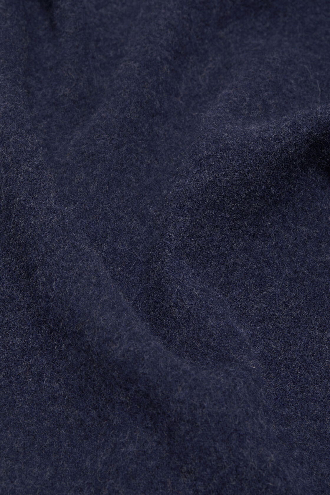 Close-up of Acne Studios narrow fringe wool scarf fabric in dark navy melange, showing a soft, lightly brushed wool texture.