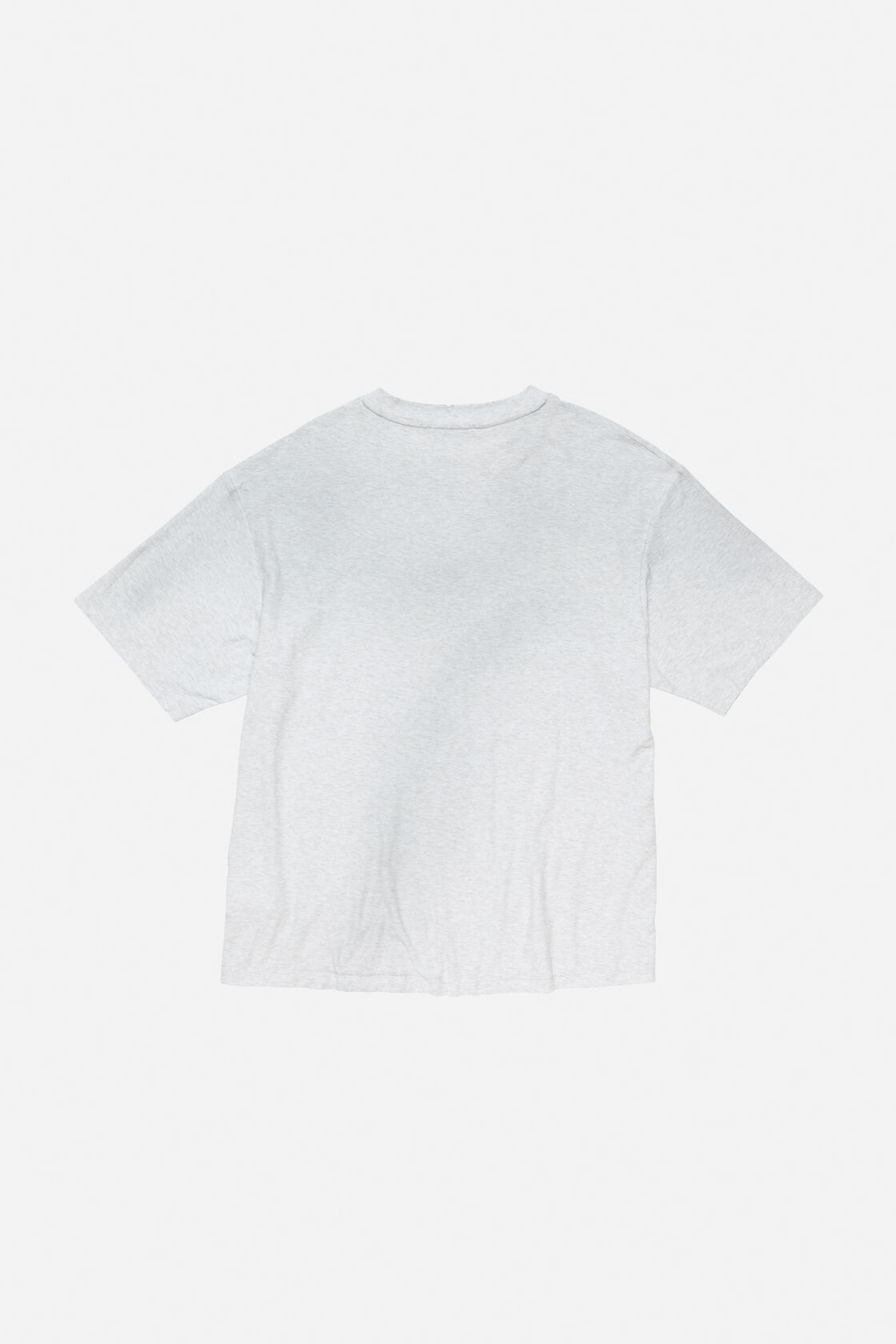 Acne Studios pale grey melange sprayed logo t-shirt, relaxed fit, worn from behind with wide-leg distressed denim jeans.