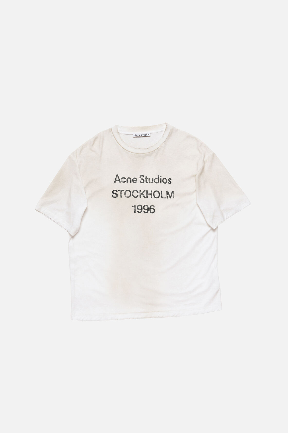 Acne Studios sprayed logo t-shirt in dusty white cotton-hemp blend jersey with crewneck, relaxed fit, and Acne Studios Stockholm 1996 text graphic on