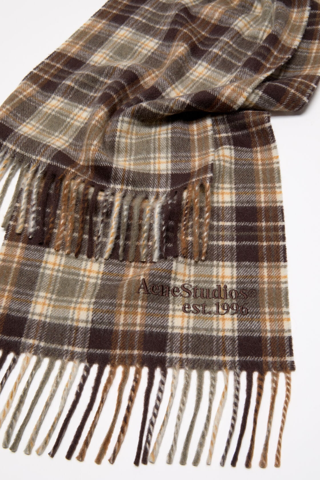 Acne Studios cashmere scarf in dark brown and khaki green plaid check, with fringed ends and embroidered logo.