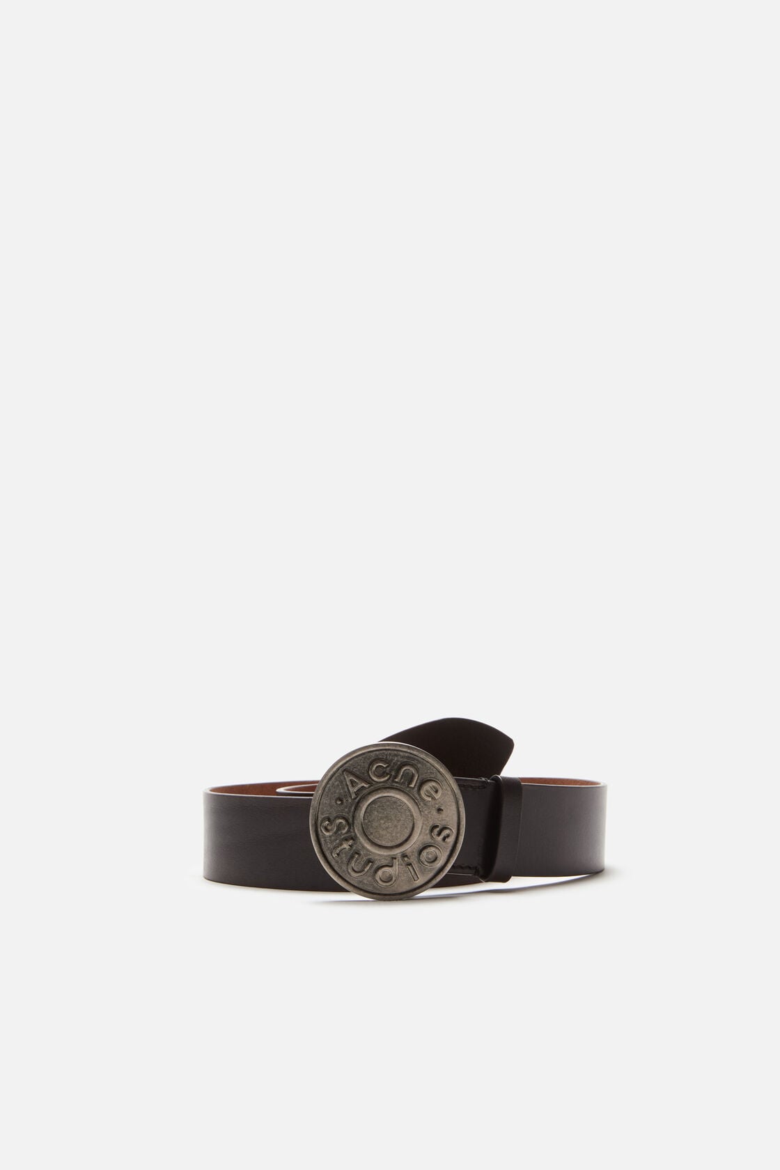 Acne Studios black leather belt with a round antique silver logo buckle on a white background.