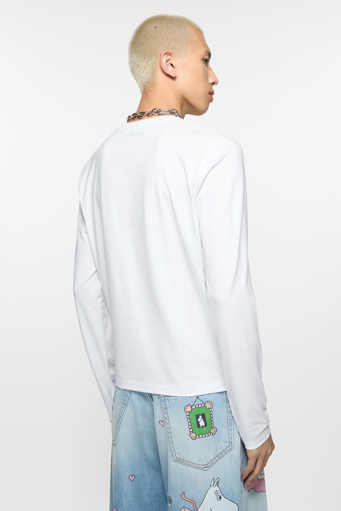 Acne Studios optic white long sleeve t-shirt in regular fit, crew neck, laid flat on a white background.