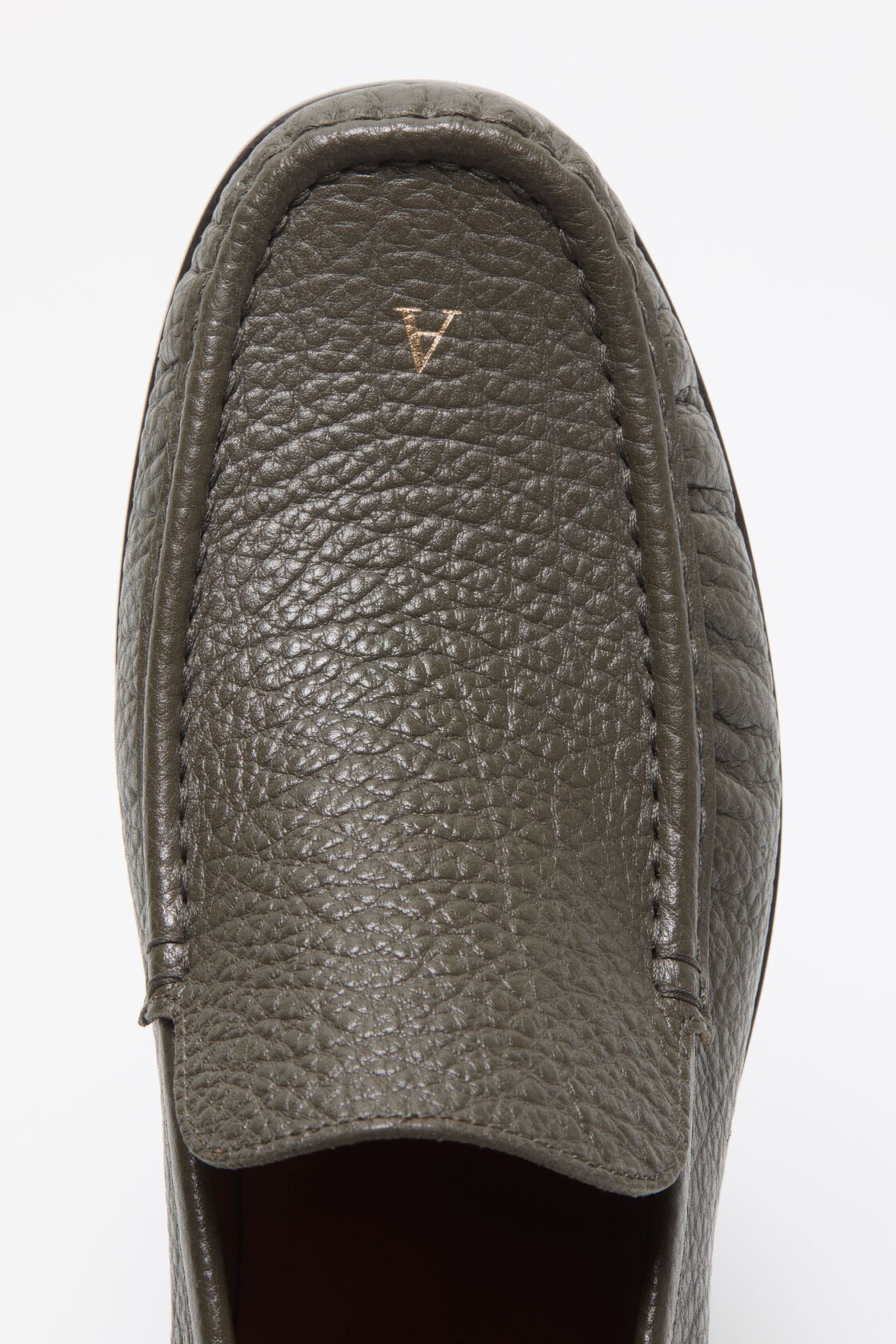 Close-up of an Acne Studios khaki green pebbled leather loafer, shown from above, with a small gold logo embossed on the toe.