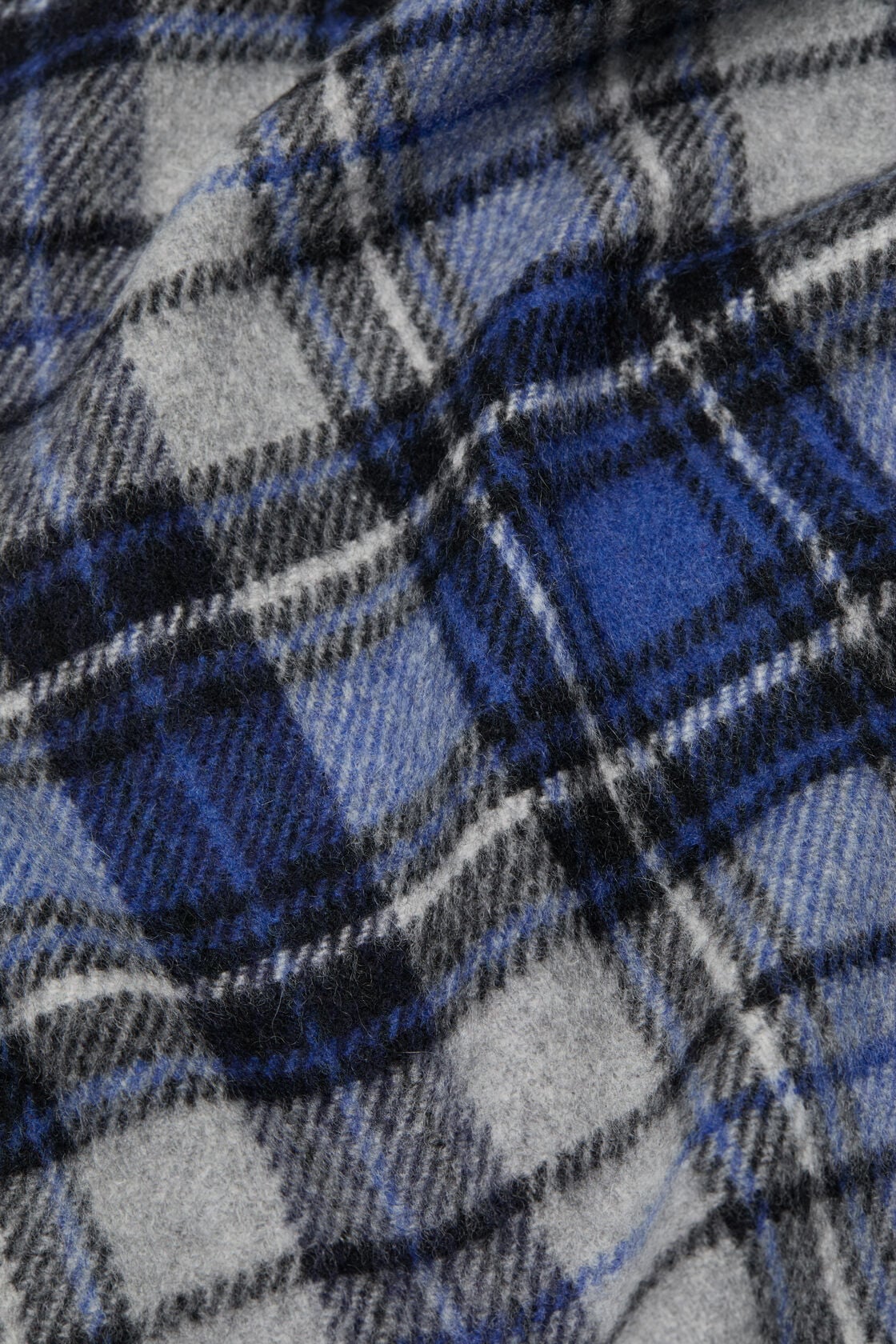 Close-up of an Acne Studios blue and grey cashmere scarf featuring a tartan check pattern with black and white accents.