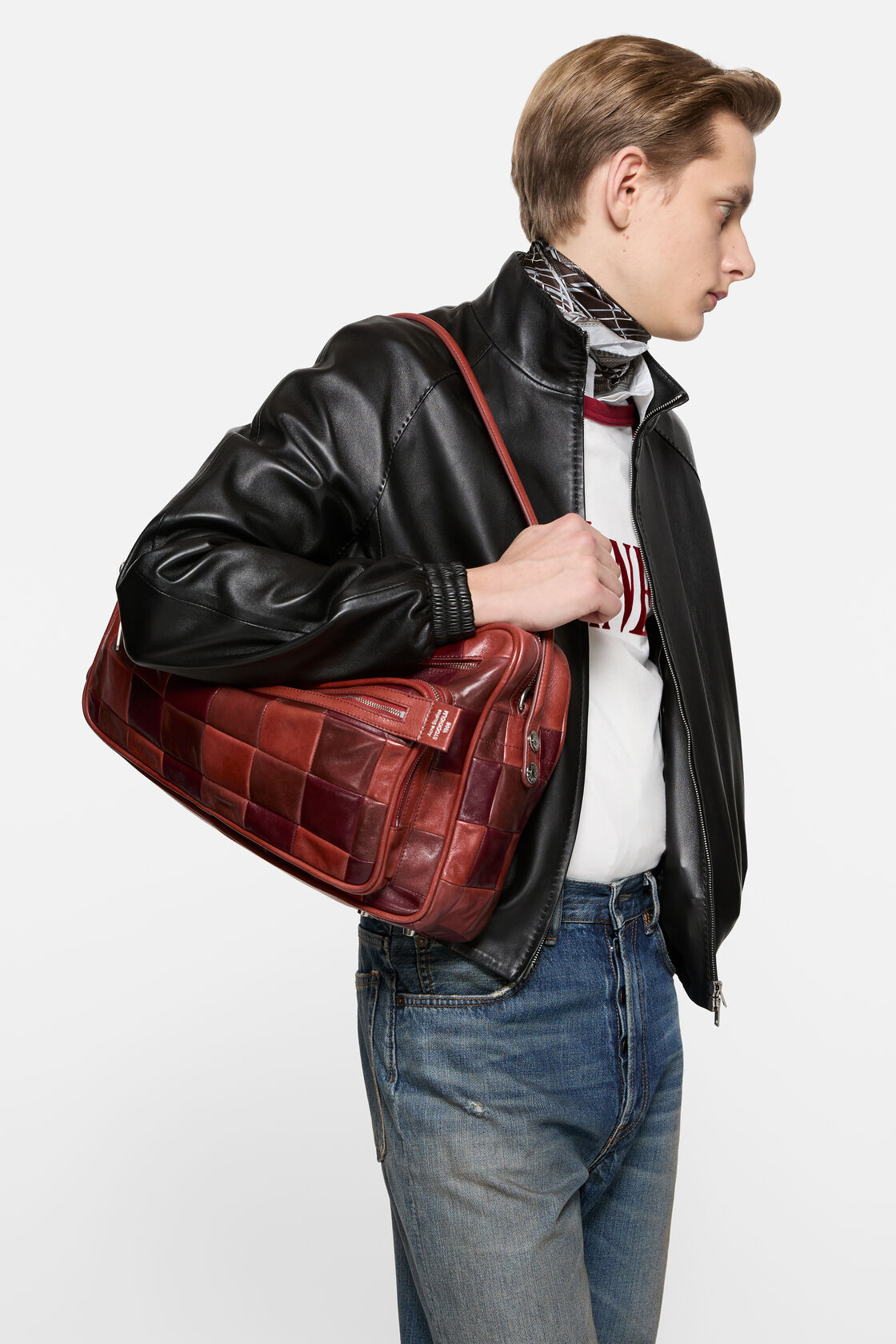 Acne Studios Camero Camera Patchwork Bag Bag in burgundy leather with woven square panels, top handle, and adjustable crossbody strap with silver-tone