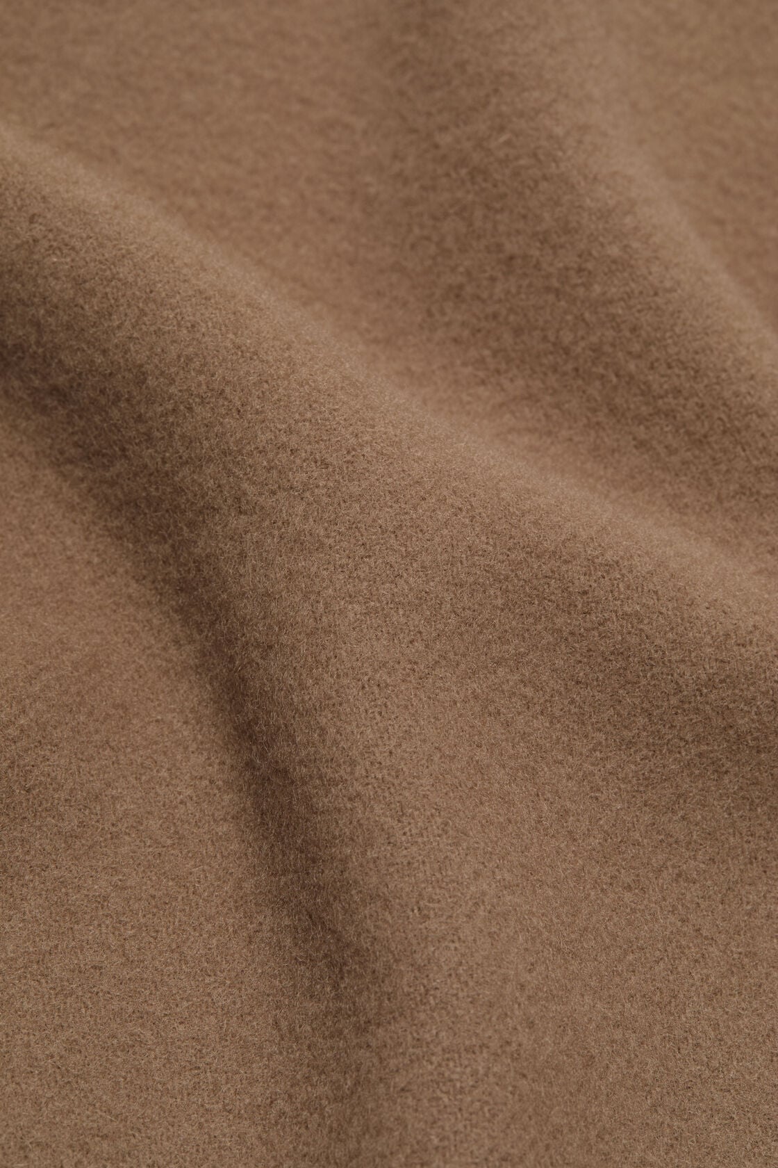 Close-up of Acne Studios fringe wool scarf in caramel brown, showing the soft, lightly textured midweight wool fabric.