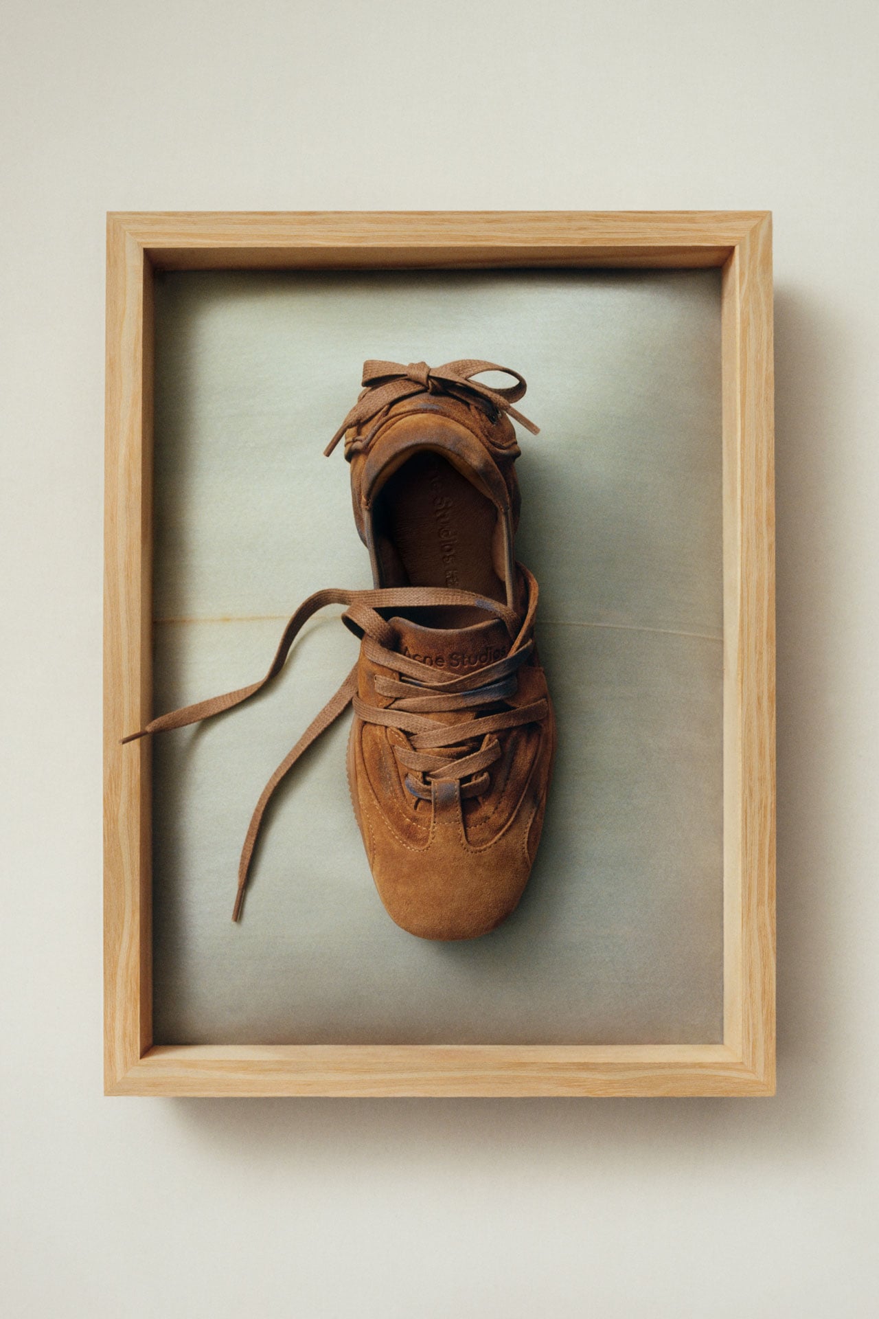 Acne Studios SS26 Summer Collection brown suede balerina sneakers presented on a tray.