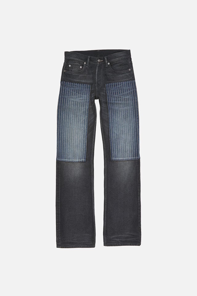 A showcase of the product of Acne Studios regular fit deep blue jeans with patchwork.