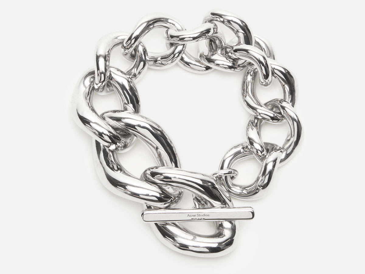 A close-up of the Acne Studios chunky silver bracelet.
