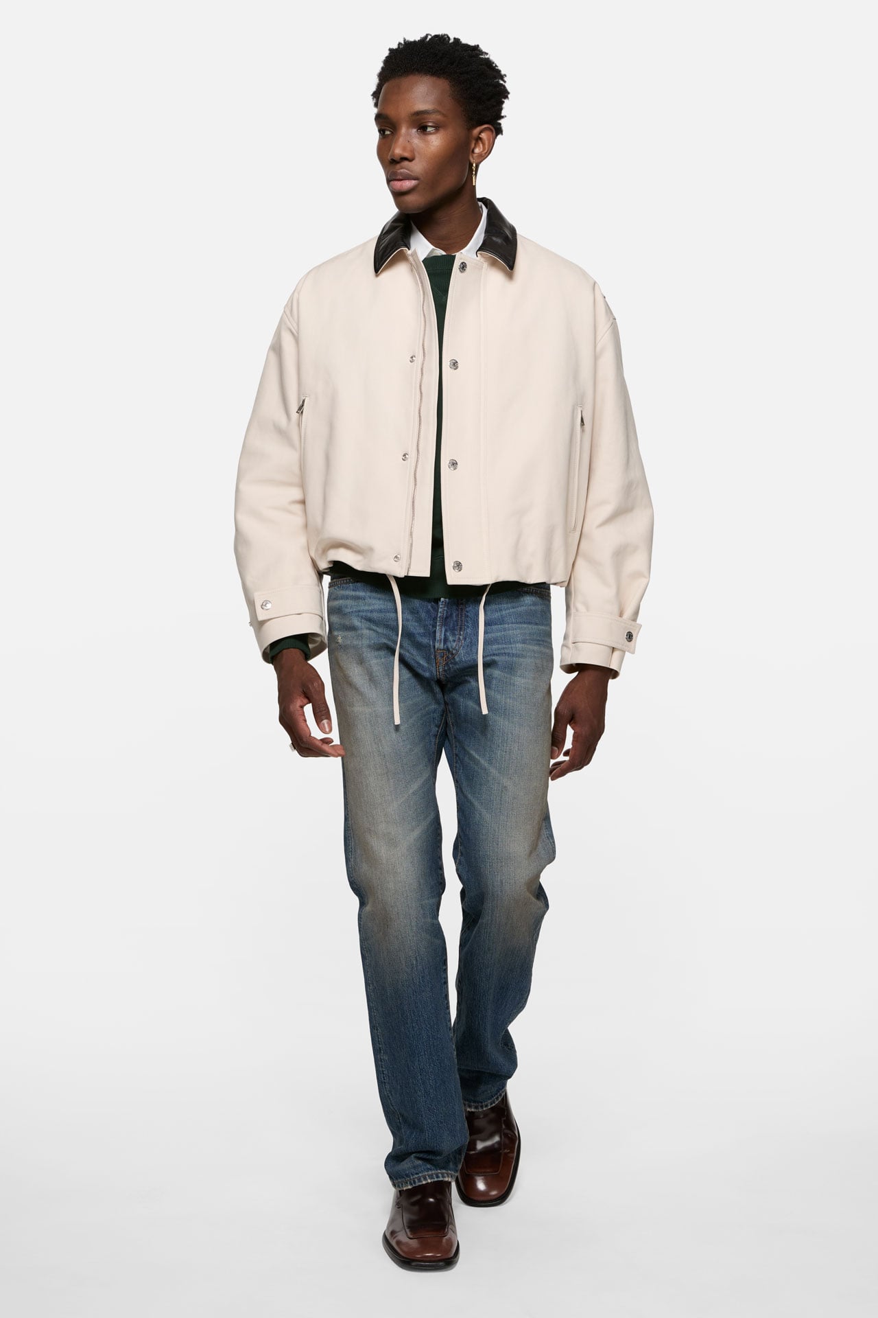 Acne Studios regular fit blue jeans with a white bomber jacket.