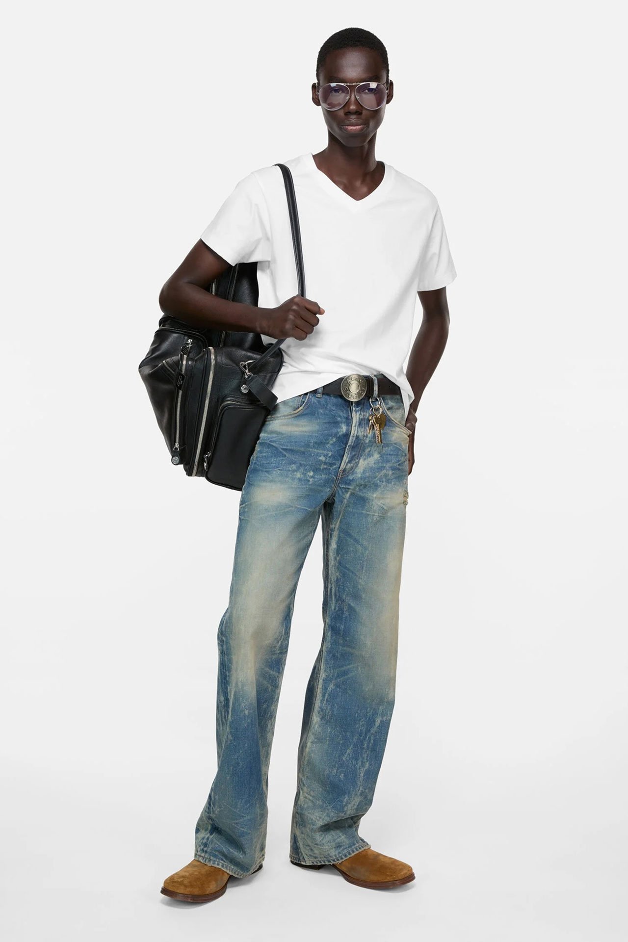 Male model showing Acne Studios new arrivals, wearing a blue bomber jacket with black leather details and green pants.