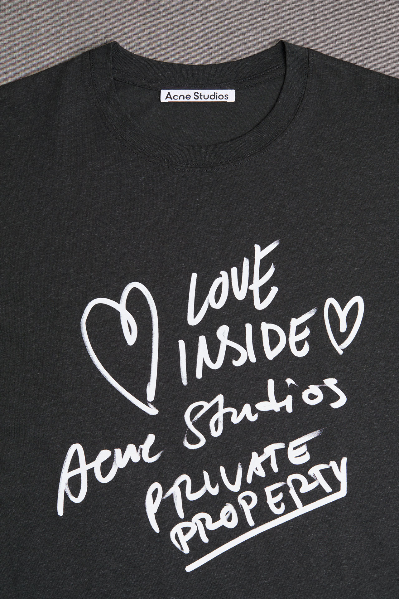 Acne Studios black t-shirt with white text.