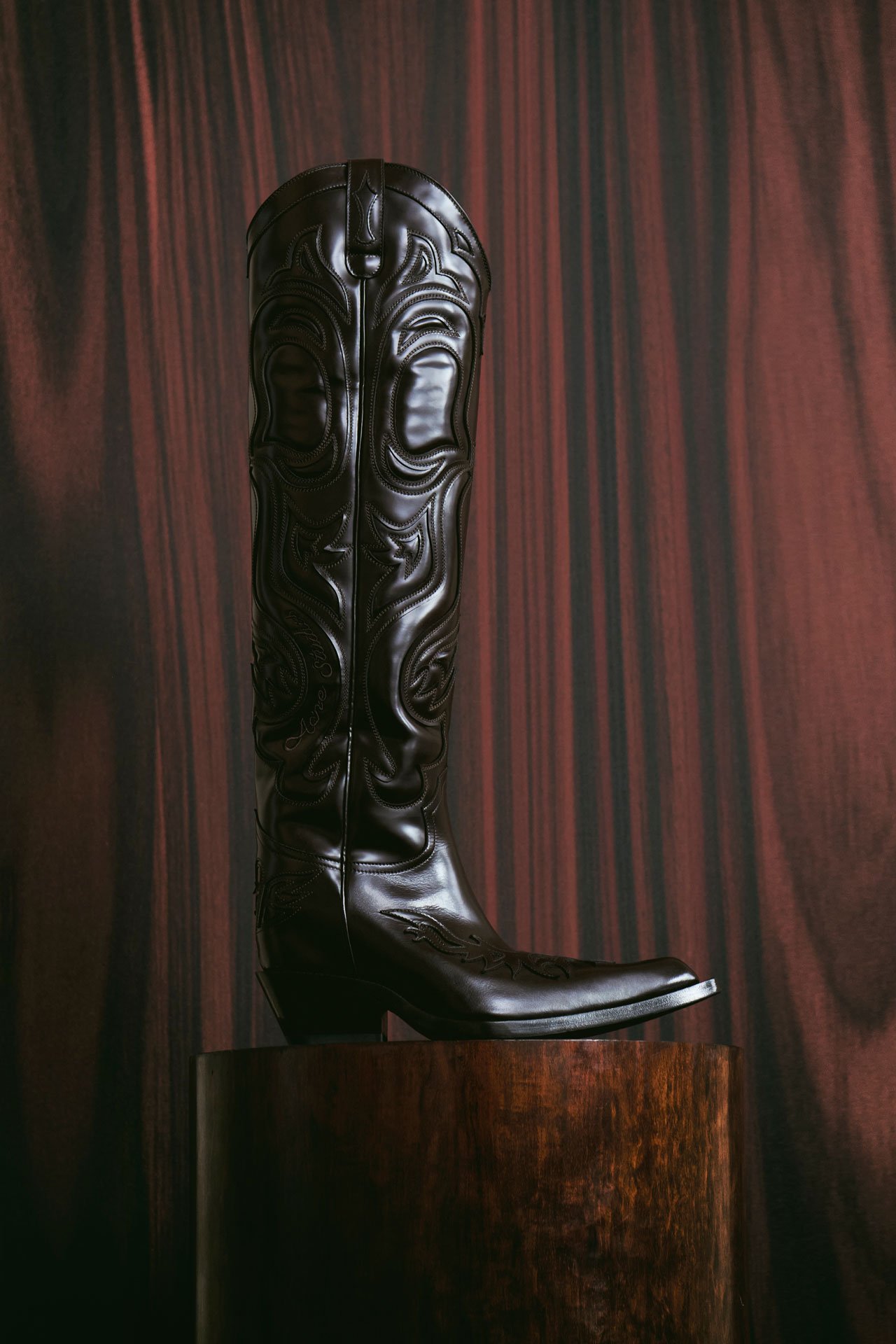 SS26 Acne Studios Paris Fashion Show long brown leather boot creative image.