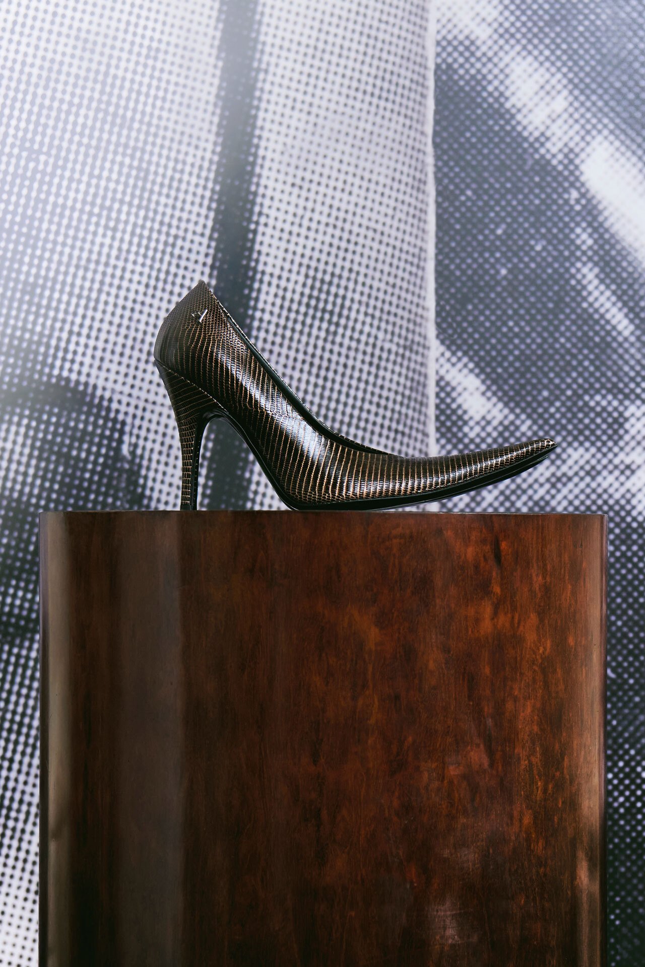 SS26 Acne Studios Paris Fashion Show brown leather high-heel on a wooden pedestral.