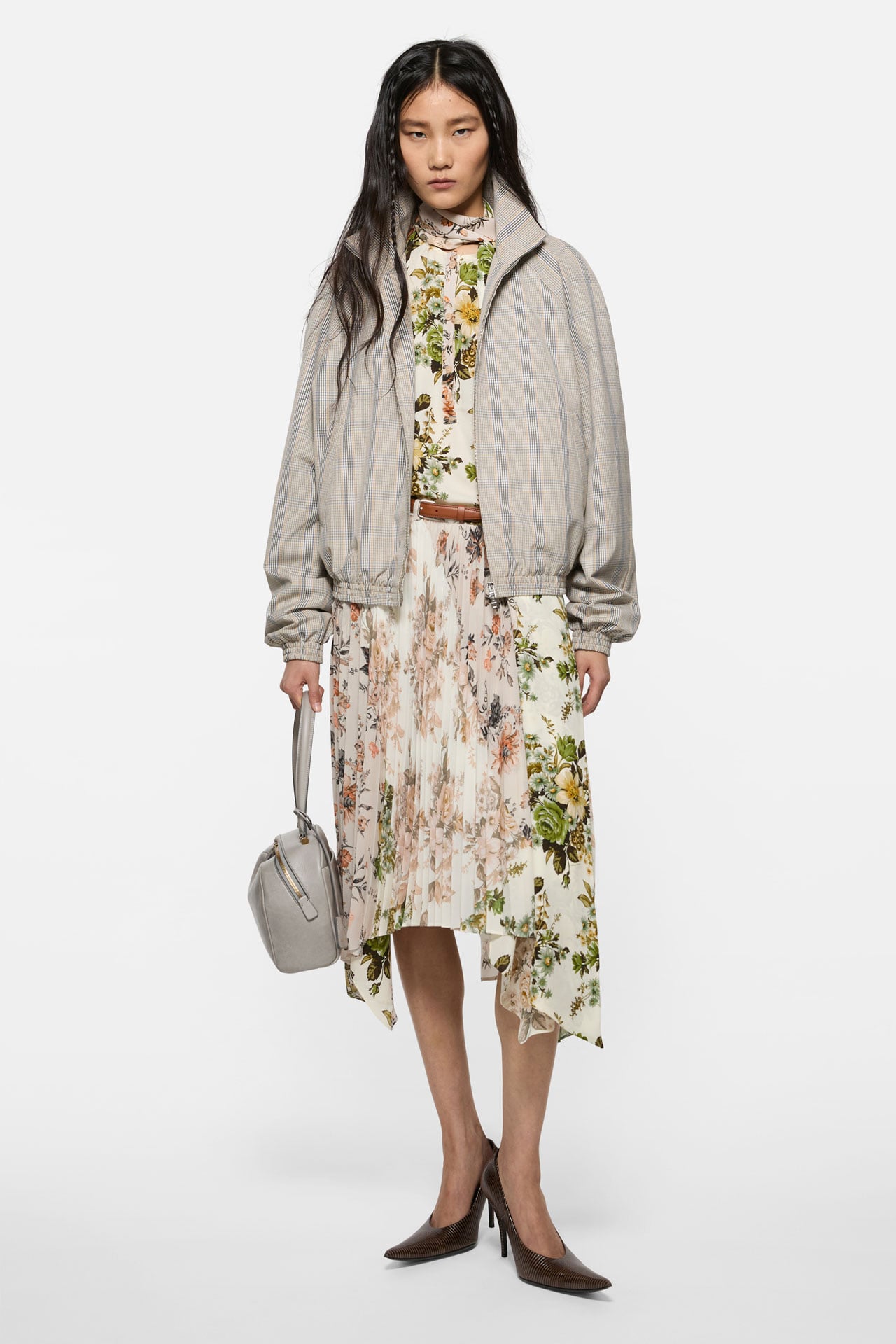Acne Studios Womenswear white, flower-printed dress with a brown belt, a beige bomber jacket brown leather high-heels and a dusty white leather bag.
