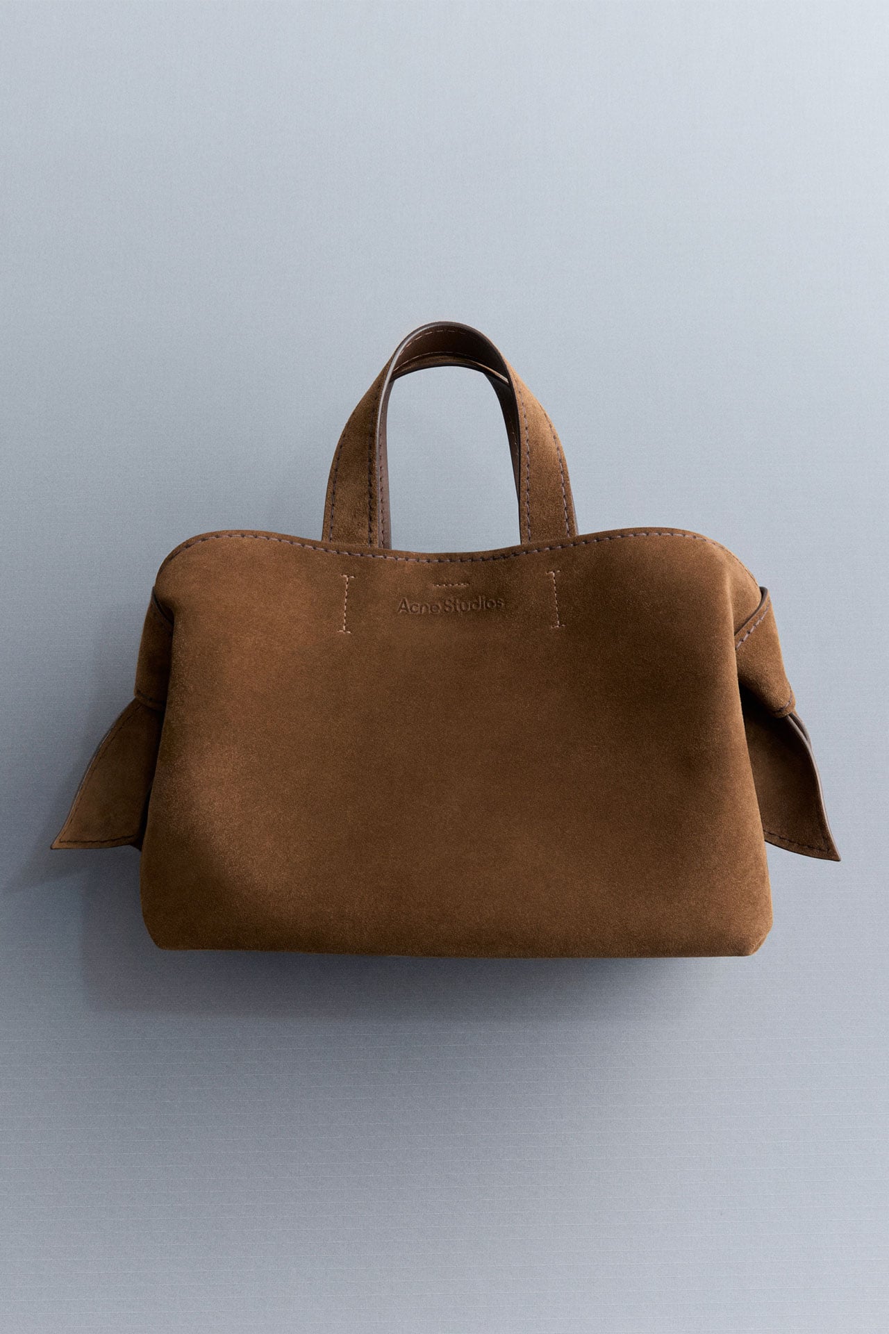 Acne Studios Musubi suede bag in cognac brown.