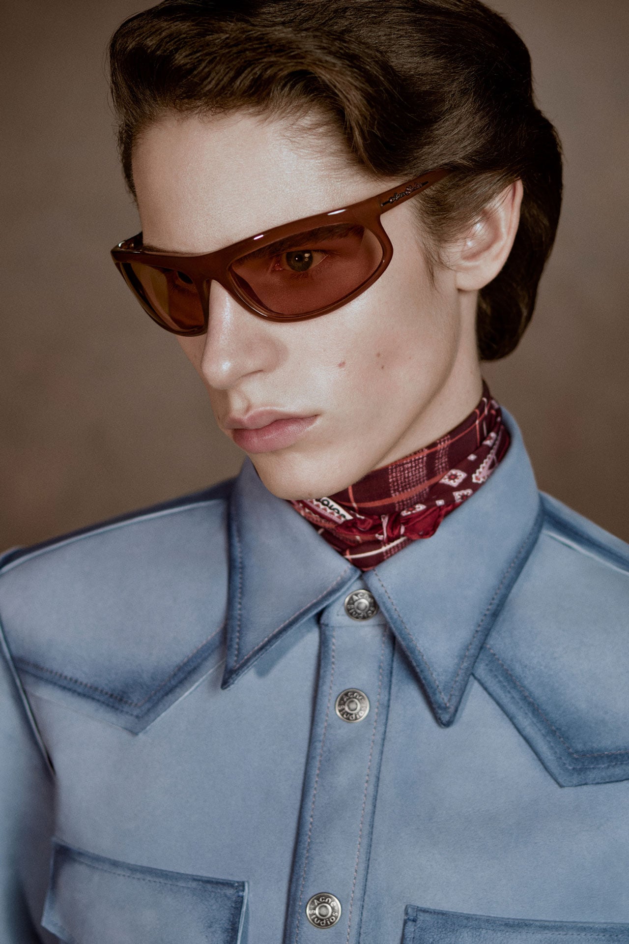 Acne Studios Menswear blue suede shirt with Acne Studios buttons, red silk scarf and brown sunglasses.