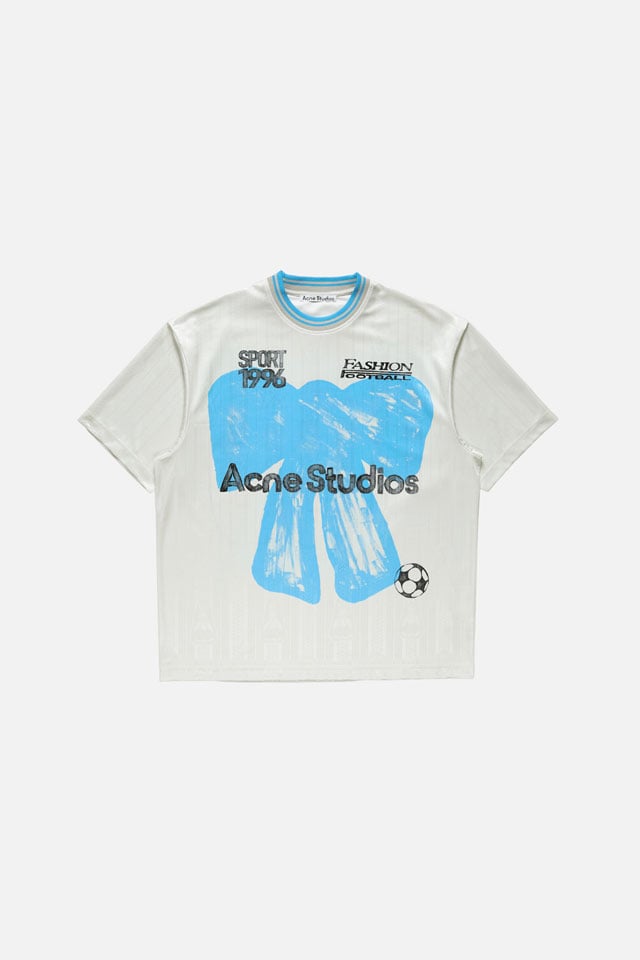 A showcase of the product: Acne Studios Football Capsule white t-shirt with a blue bow print.