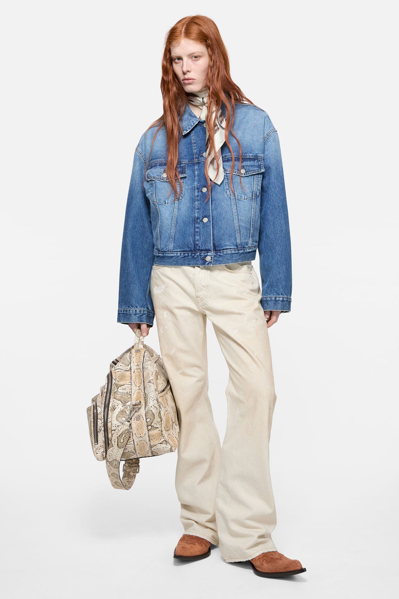 Female model wearing a pair of pink jeans, black layered long-sleeved t-shirt, and transparent Aviator sunglasses.