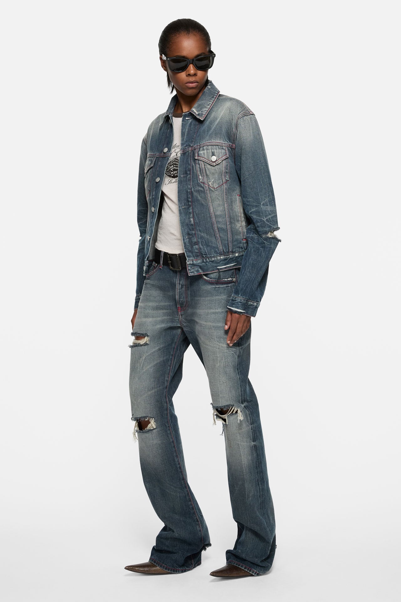 Acne Studios Womenswear 30 Years collection denim jacket and ripped jeans, white t-shirt and black sunglasses.