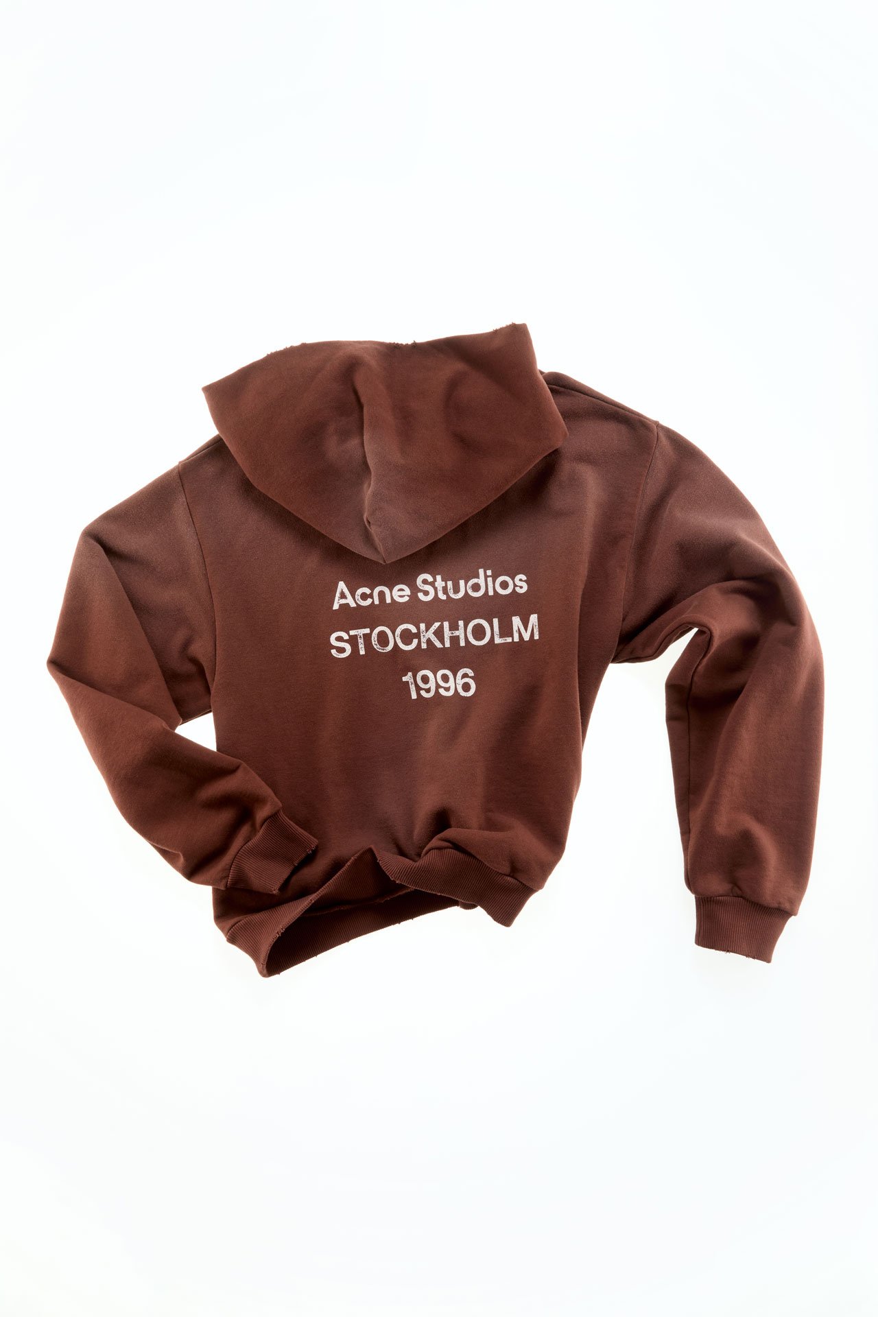 A creative showcase of an Acne Studios 1996 logo brown hoodie.