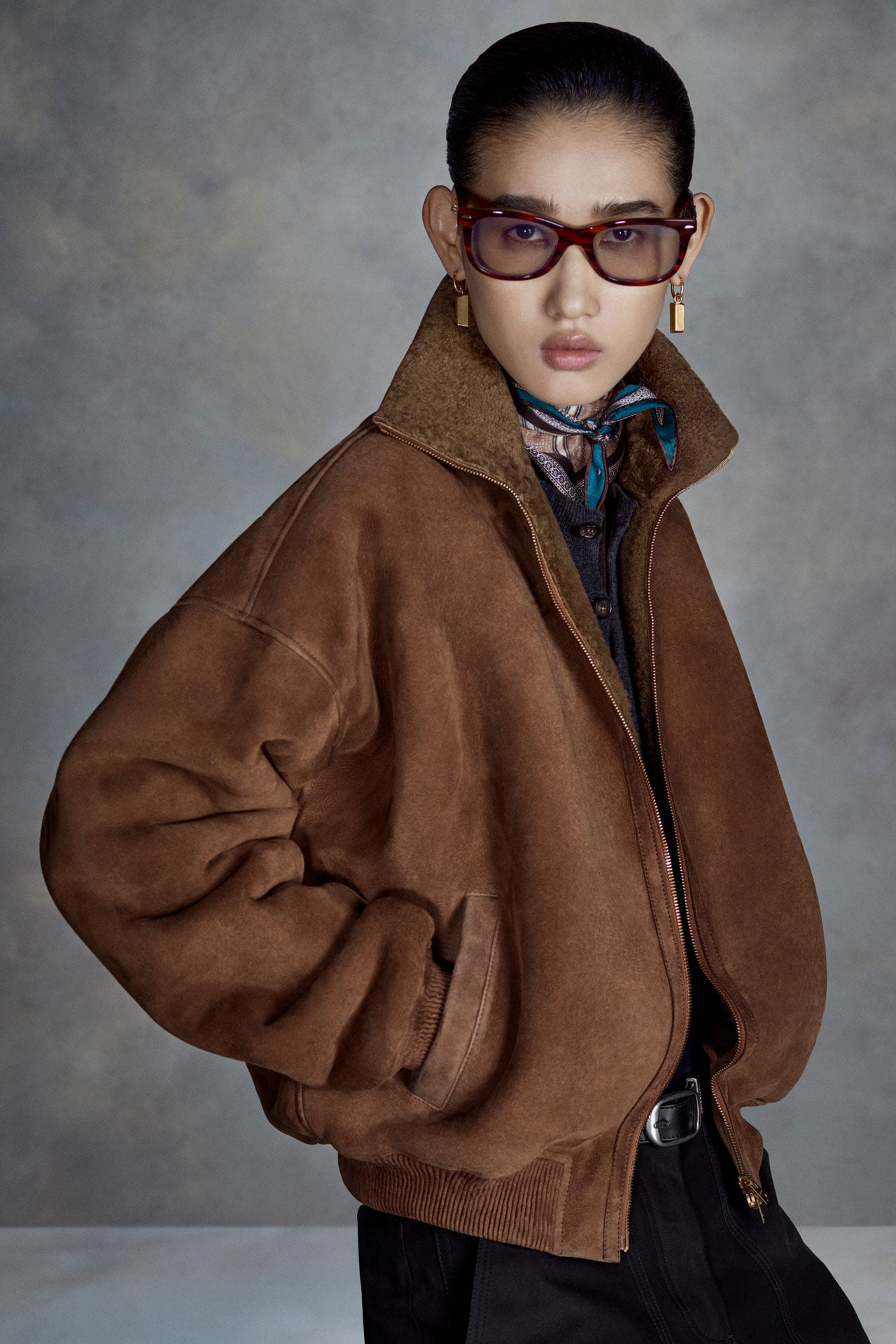 Acne Studios Womenswear 30 Years collection black bomber jacket and brown skirt.