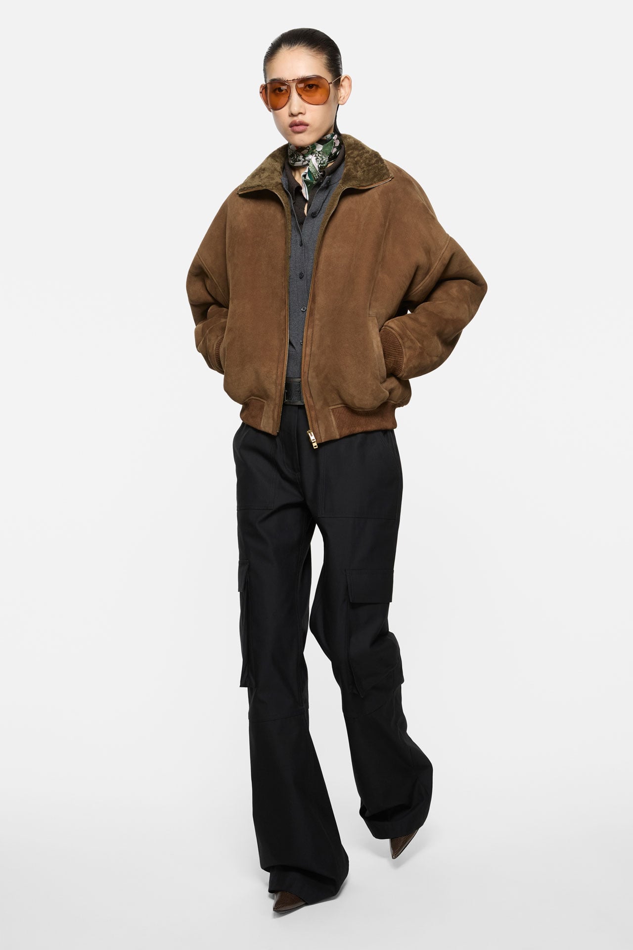 Acne Studios Womenswear beige checked shirt, brown tailored skirt-pants, brown suede Camero bag.
