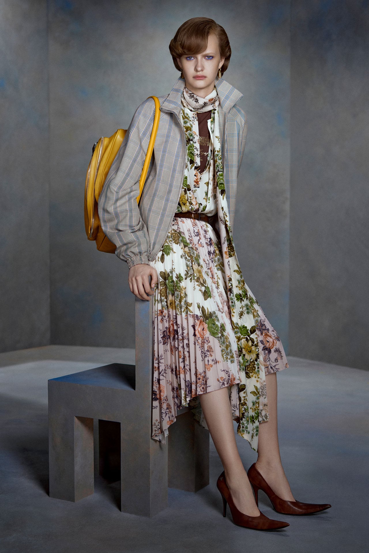 Acne Studios beige-white flower print silk shirt dress, brown leahter high-heels, beige bomber jacket and a yellow leather Camero bag.