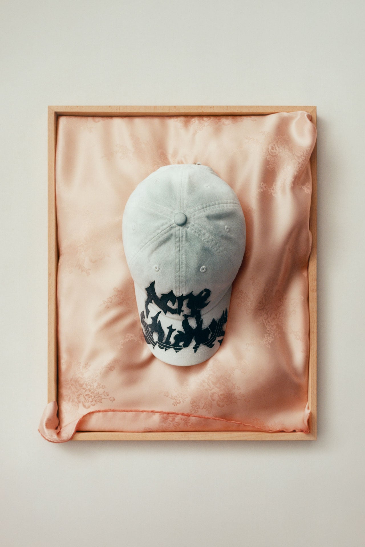 Acne Studios SS26 Summer Collection white, black logo-printed cap.