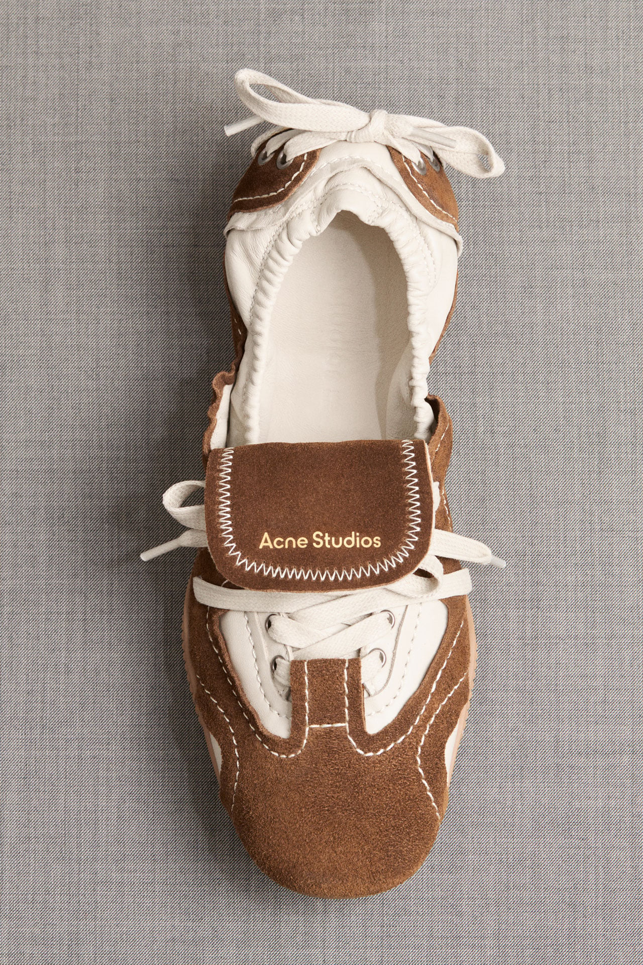 Acne Studios brown suede Bilaria lace-up shoe with white leather details.