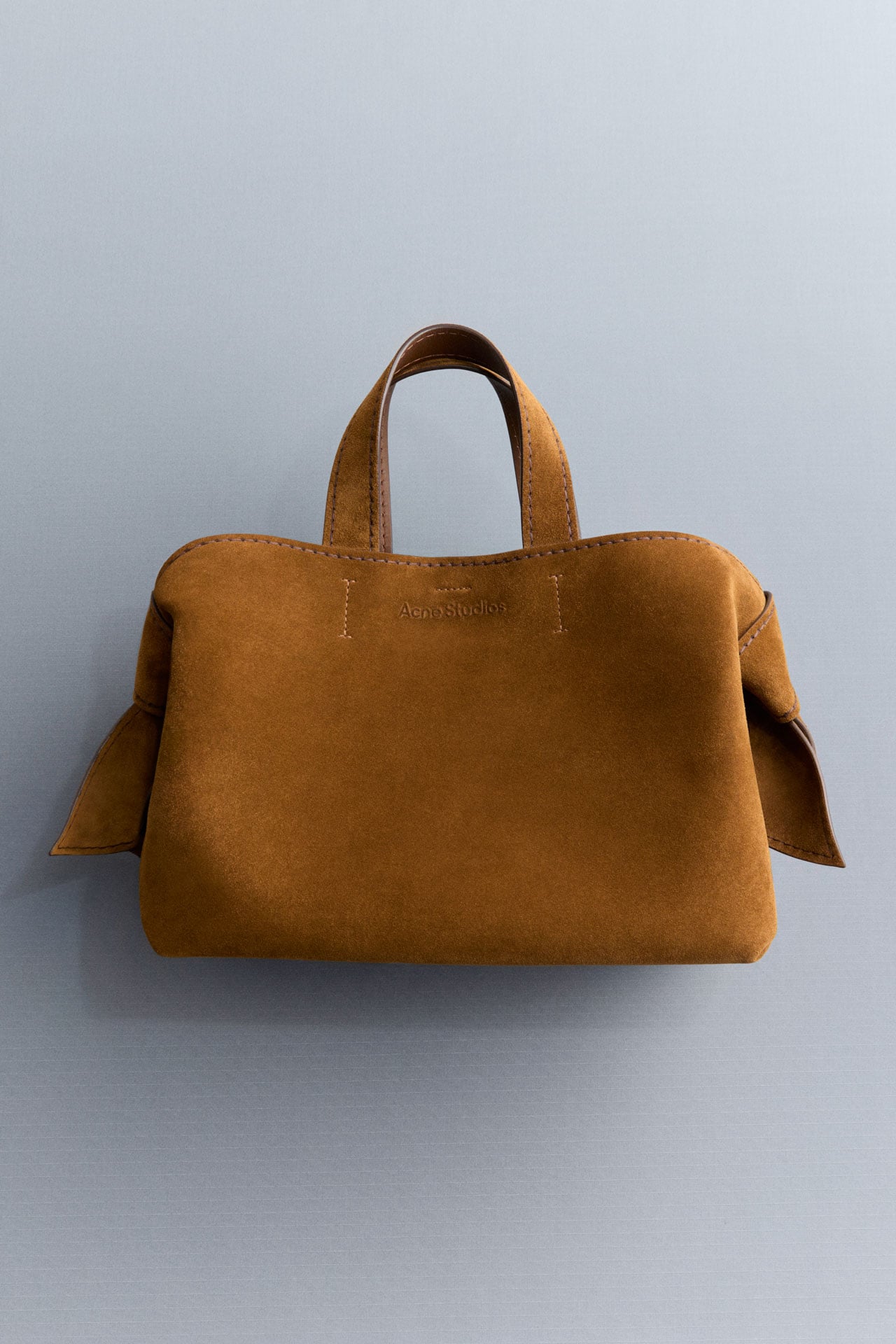 Acne Studios Musubi suede bag in cognac brown.