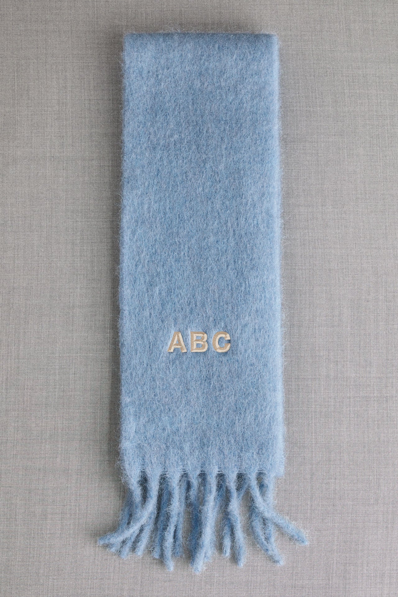 Acne Studios light blue skinny mohair scarf.